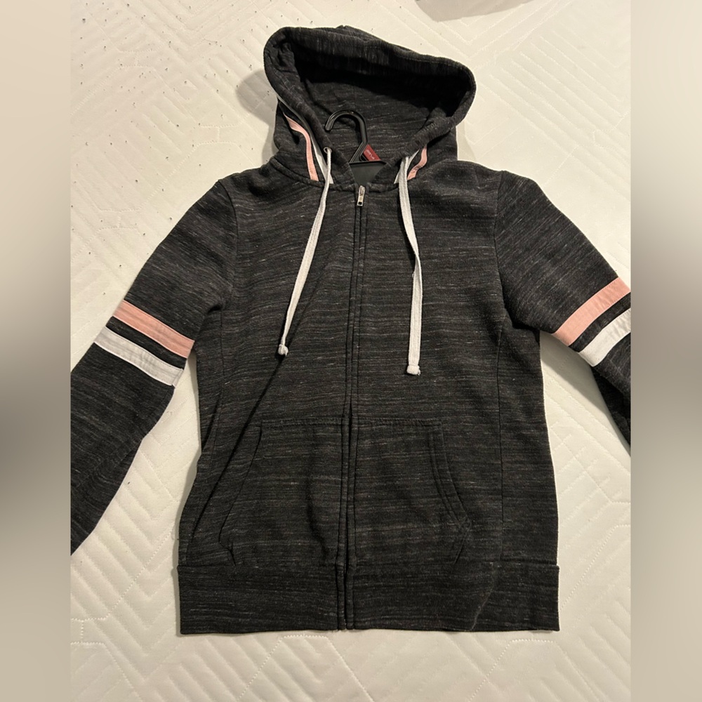 Dark grey zip up hoodie with white and pink stripes